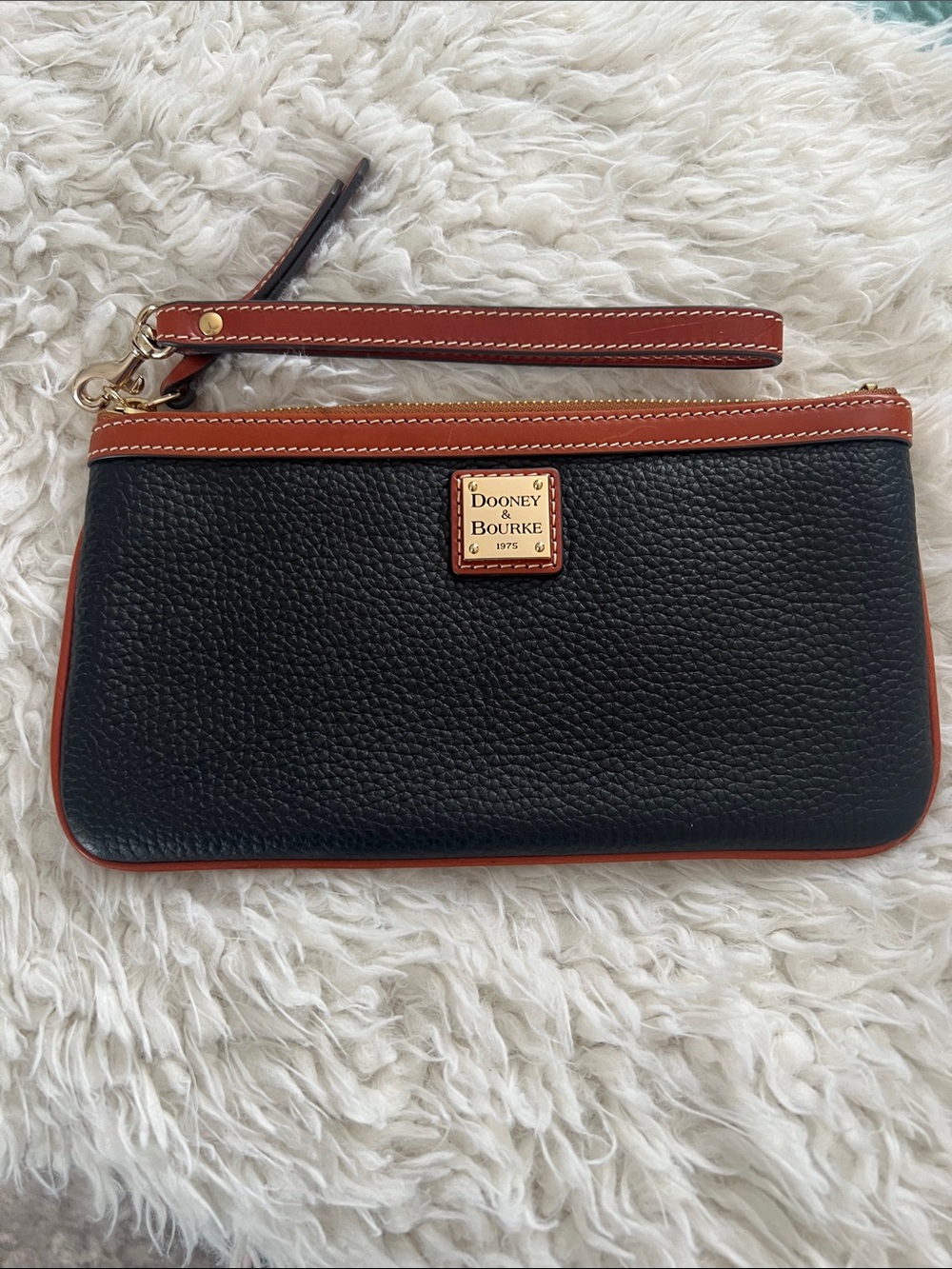 Dooney & Bourke Black Pebbled Leather Wristlet with Brown Trim and Gold Plaque